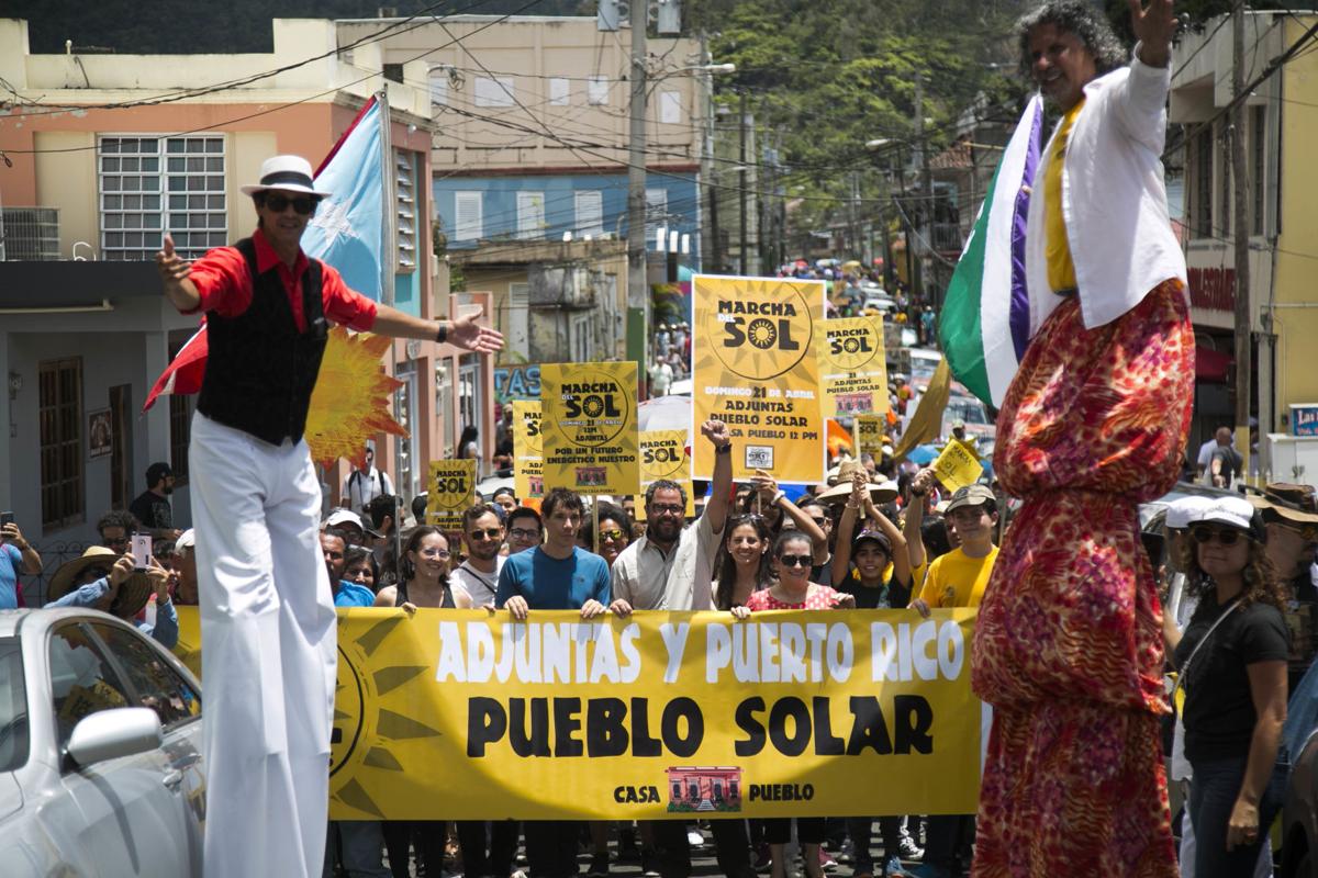Arturo Massol-Deya and Alex Hannold lead the Casa Pueblo "Marcha Sol" protest down the street in Puerto Rico.